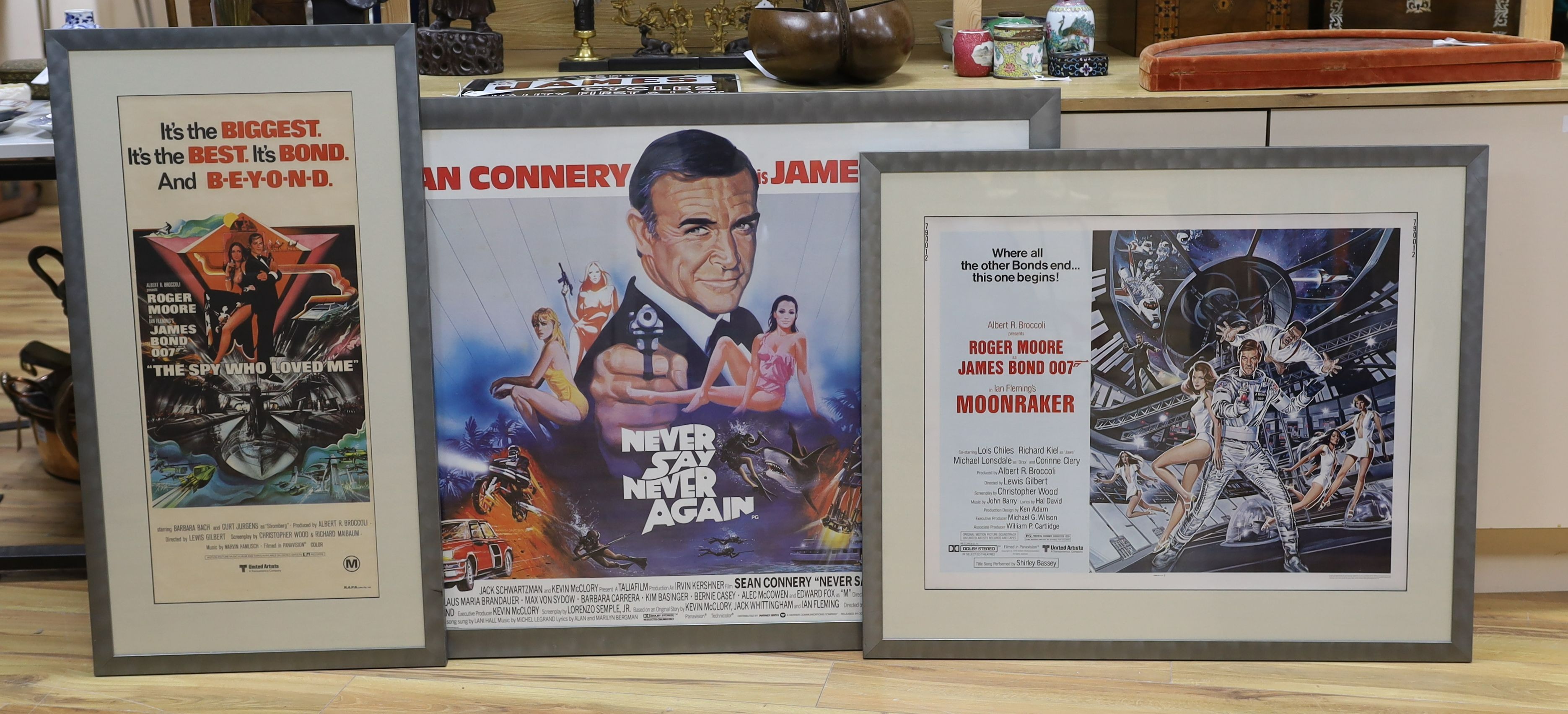 James Bond. Three assorted film posters: Never Say Never Again, 75 x 100cm; Moonraker, 55 x 70cm and The Spy Who Loved Me, 75 x 33cm
